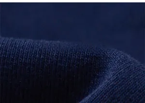 Macro detail of soft navy blue ribbed knit fabric showing high-quality textile texture