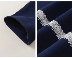Detail of navy blue knit shirt featuring ribbed cuffs and delicate white wavy lace trim