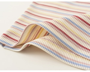 Close-up of rainbow striped ribbed knit fabric with high-quality white hem stitching