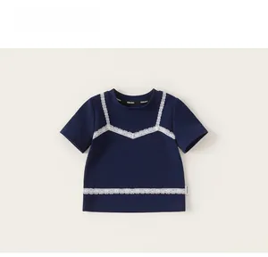 Detailed view of girls navy blue t-shirt with elegant white lace layered design