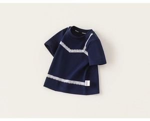 Detail of navy blue kids' cotton T-shirt with white lace trim and brand woven labels
