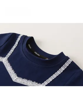 Close-up of dark blue knit top featuring white eyelash lace trim at the neckline