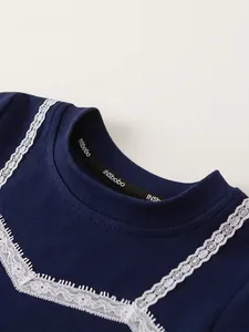 Girls dark blue short sleeve knit top with delicate white lace collar detail