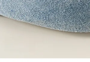 Macro shot of blue denim fabric showing the detailed twill weave and soft texture