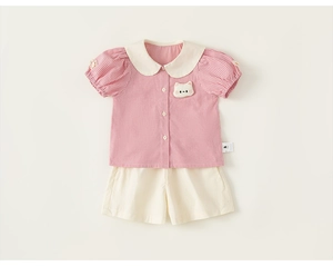 Detail of pink plaid shirt with peter pan collar and cute cartoon animal patch