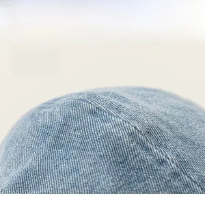 Close-up of the light blue twill denim fabric and precision stitching on the hat crown