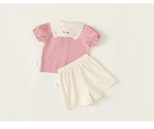 Detail of pink plaid shirt with doll collar and matching white shorts for toddler girls