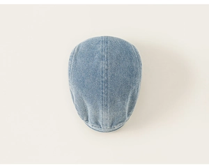 Top-down view of a light blue denim beret cap for kids with washed denim texture