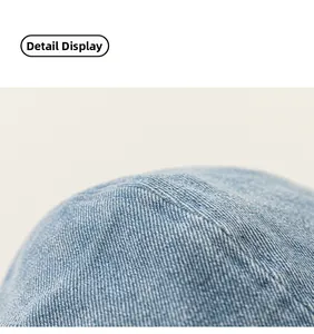 Detailed close-up showing blue denim fabric texture and precise stitching on kids beret cap