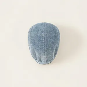 Light blue washed denim beret cap for kids featuring vintage twill texture on a plain background