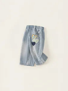 Girls' light blue denim trousers with colorful heart patches and elastic waist