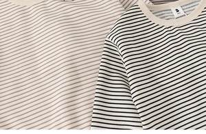 Close-up of cotton striped kids t-shirts showing soft fabric texture and ribbed neckline