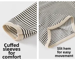 Detail of striped cotton long sleeve top showing hem side split and hem binding cuffs