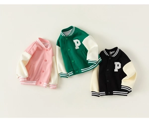 Detailed view of color-block kids baseball jackets with P-patch in pink, green, and black