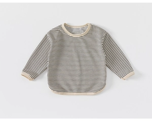 Close-up detail of cream long-sleeve toddler T-shirt with black stripes and ribbed cuffs