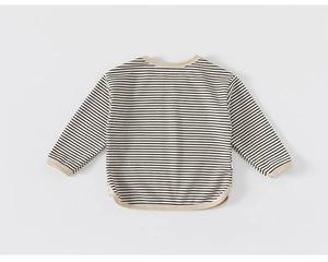 Detail view of the striped kids long sleeve t-shirt showing the ribbed cuffs and side slit