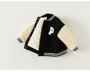 Detail of children's varsity jacket with diamond quilted lining and letter P patch