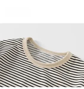 Close-up of the cream ribbed crew neck and neat stitching on a striped cotton T-shirt