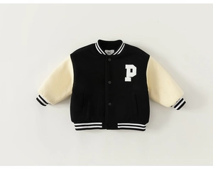 Detail of kids varsity jacket with white letter P patch and striped ribbed cuffs