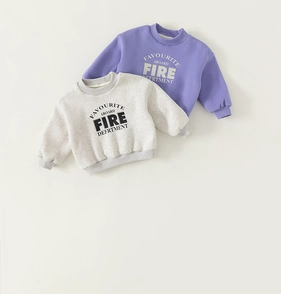 Flat lay of purple and beige fleece sweatshirts for kids with letter print details