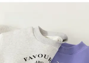 Close-up of ribbed neckline and soft knit fabric on children's letter print sweatshirts