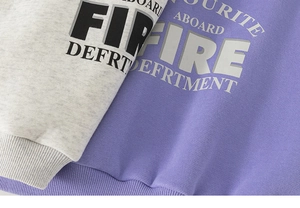 Close-up of thick fleece sweatshirts with letter print and ribbed cuffs detail