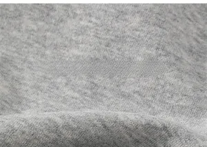 Close-up of soft grey knitted fabric texture on children hooded sweatshirt