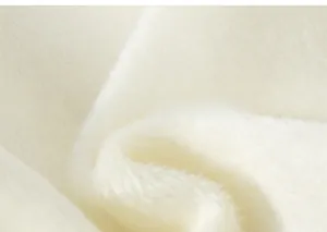 Close-up of soft white faux fur fabric texture for children's winter fleece sweatshirt