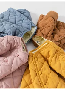 Detail view of quilted diamond pattern puffer vests with matching resin buttons