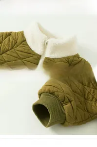 Detail of olive green quilted jacket featuring white fleece collar and ribbed cuffs