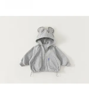 Detailed close-up of kids grey zip-up hoodie with bear ears and logo print on hood