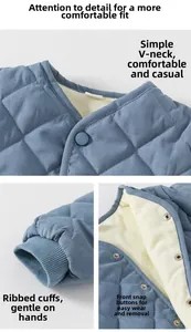 Detail of baby quilted jacket featuring V-neck design, ribbed cuffs and snap button closure