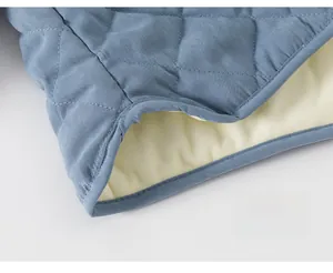 Detail of blue quilted toddler coat showing even stitching and warm fleece lining