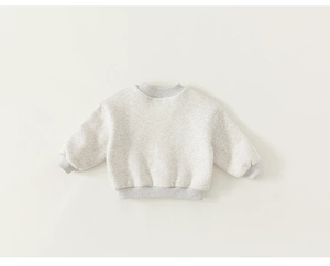Close-up of a warm grey fleece-lined sweatshirt with soft cotton texture and ribbed cuffs