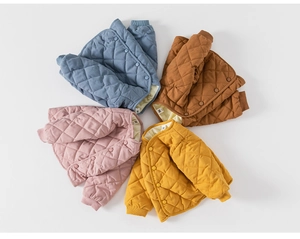 Close-up of diamond-quilted infant jackets with resin buttons and ribbed cuffs in four colors