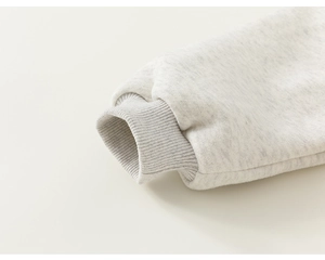 Macro detail of high-density heather grey cotton ribbed cuff with fleece inner lining