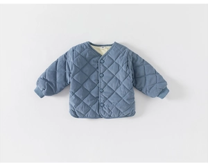 Close-up of diamond-quilted blue kids jacket featuring V-neckline and ribbed cuffs
