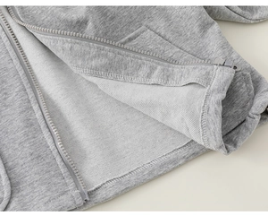 Detailed macro view of gray cotton hoodie with french terry lining and smooth zipper track