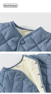 Detail of blue quilted cotton vest featuring snap buttons and soft warm lining