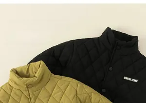 Detail showing diamond quilted texture and snap buttons on kids padded jackets