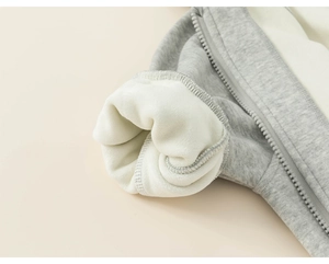 Detail view of children's grey hoodie featuring thick white sherpa fleece lining for winter warmth