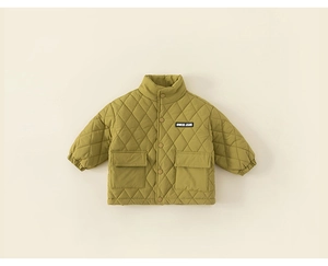 Detail view of mustard yellow quilted kid jacket with large pockets and button closure
