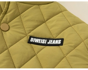 Close-up of olive green quilted jacket featuring diamond stitching and brand label detail