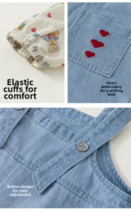 Details von elastischen Bündchen und Herzstickerei am Mädchen-Latzhosen-Set