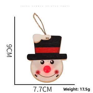 Detail of wooden snowman Christmas ornament with glowing nose and rustic hemp rope hanger