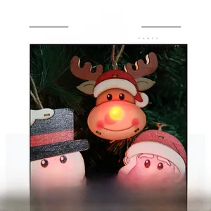 Detailed view of wooden Christmas ornaments featuring glowing LED light and cartoon reindeer
