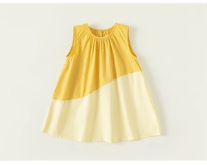Close-up of yellow and beige patchwork A-line dress with pleated neckline and button back