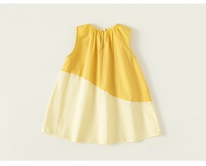 Detail of child sleeveless A-line dress with yellow and beige patchwork and pleated neckline