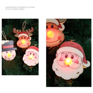 Detail of wooden Christmas ornaments with LED lights featuring Santa, snowman and deer