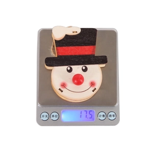 Detailed view of handmade snowman wooden Christmas ornament showing 17.5g weight on scale